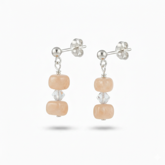 Peach moonstone sterling silver earrings with soft salmon shimmer, elegant feminine gemstone jewellery for everyday wear or wedding styling.