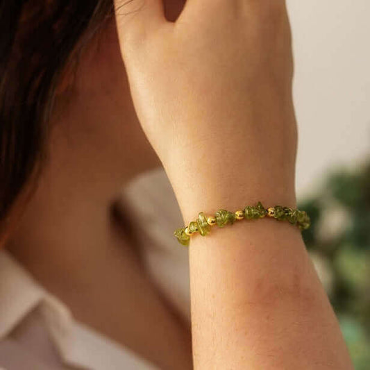 Peridot crystal bead bracelet worn on wrist, handmade birthstone jewellery for August