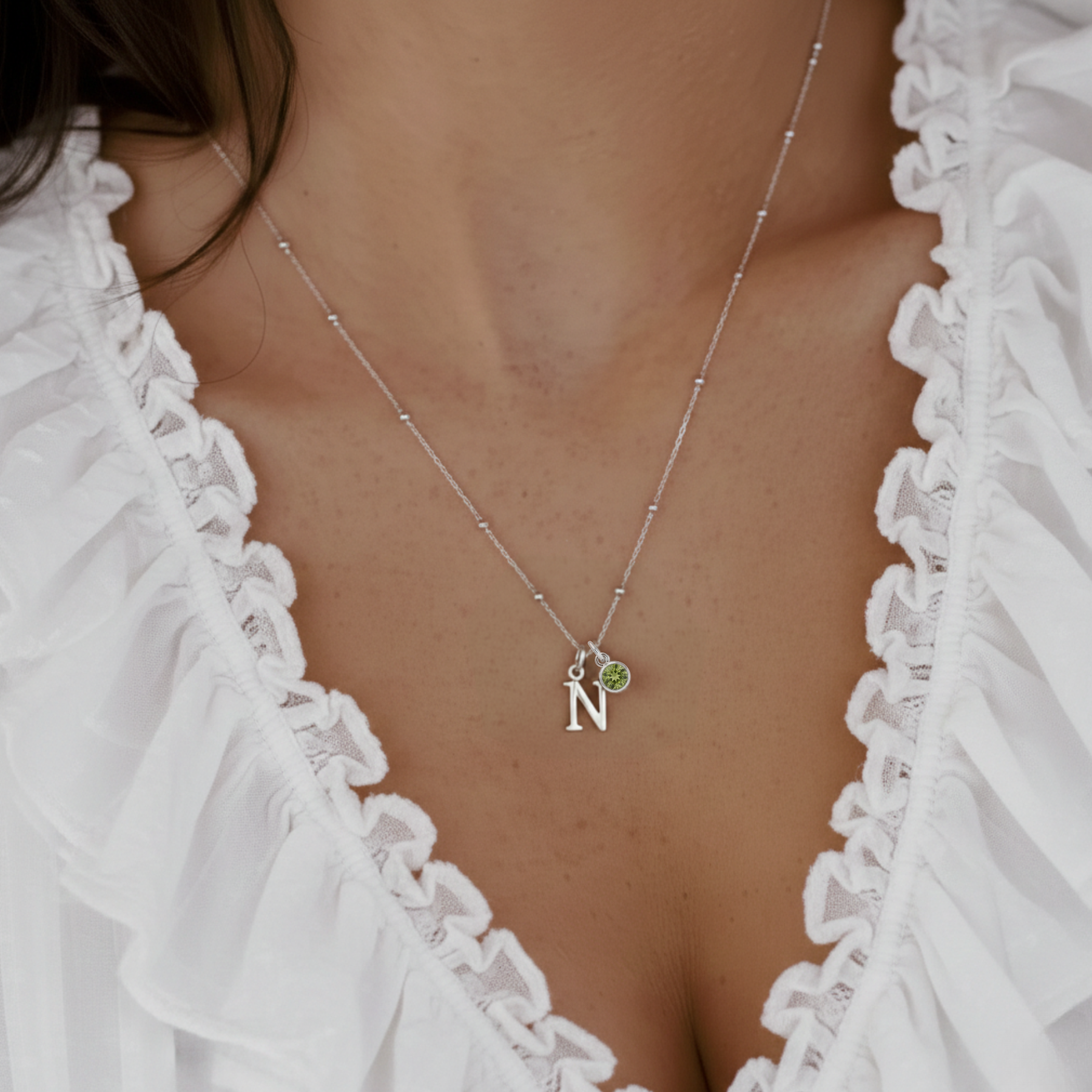 Peridot August birthstone necklace with personalised initial letter charm in sterling silver, meaningful custom jewellery gift.