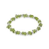 Peridot crystal bead bracelet with faceted green gemstones and sterling silver beads on a stretch design.