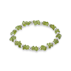 Peridot crystal bead bracelet with faceted green gemstones and sterling silver beads on a stretch design.