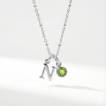 Personalised August birthstone necklace with peridot gemstone charm on a sterling silver chain.