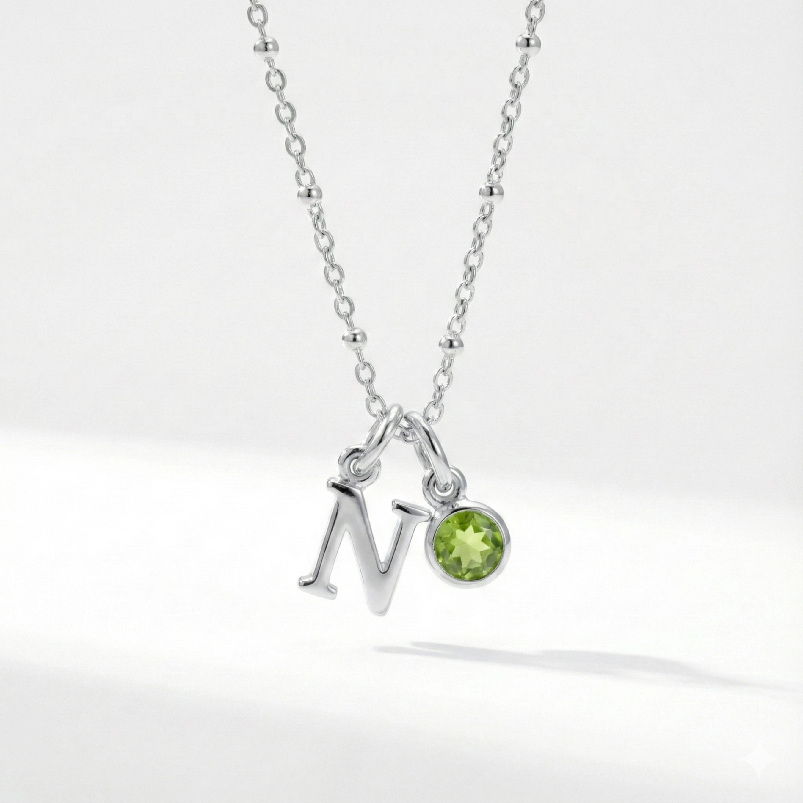 Personalised August birthstone necklace with peridot gemstone charm on a sterling silver chain.