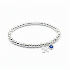 Sapphire and initial charm bracelet in sterling silver, September birthstone personalised gift for her.