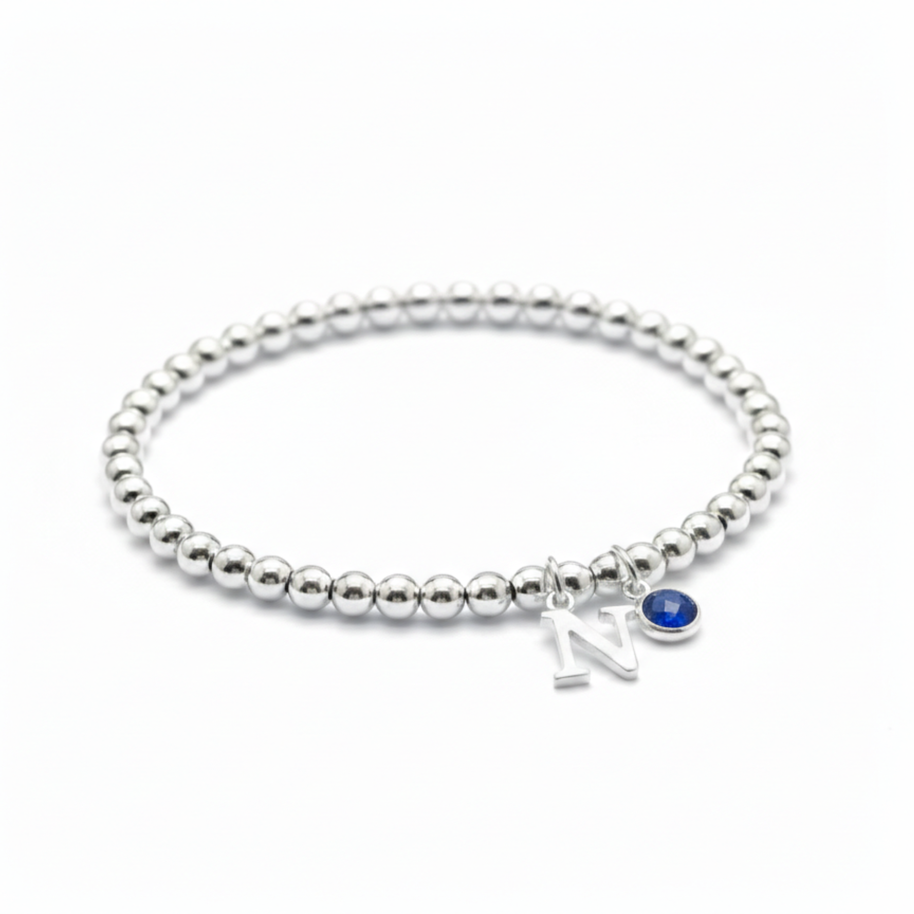 Sapphire and initial charm bracelet in sterling silver, September birthstone personalised gift for her.