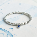 Sapphire September birthstone charm bracelet, sterling silver stretch bracelet UK