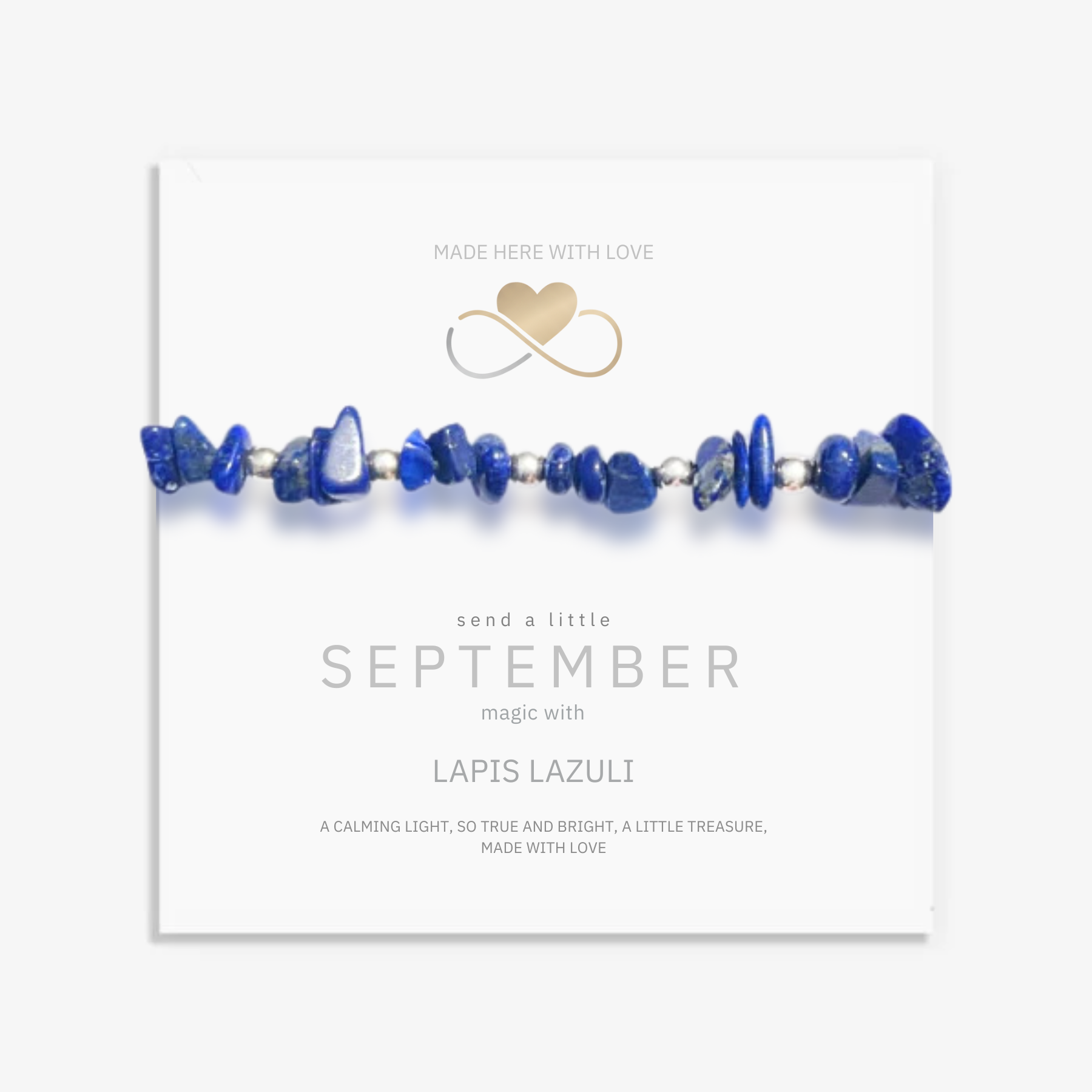 Lapis lazuli September birthstone jewellery displayed on gift card, deep blue gemstone gift ready for presentation.