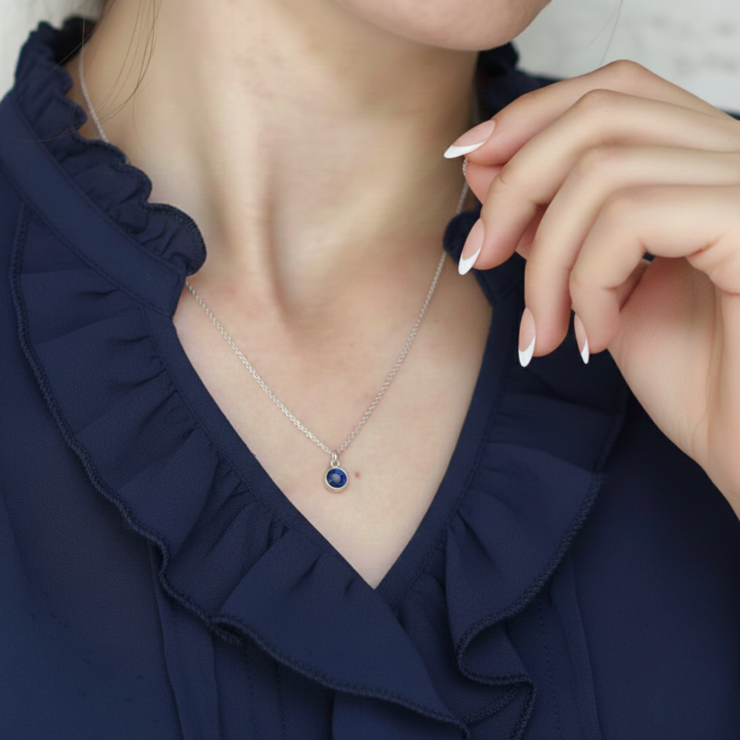 September birthstone sapphire charm necklace shown worn on chain