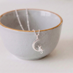 Silver cat charm necklace with moon detail, handmade animal jewellery UK