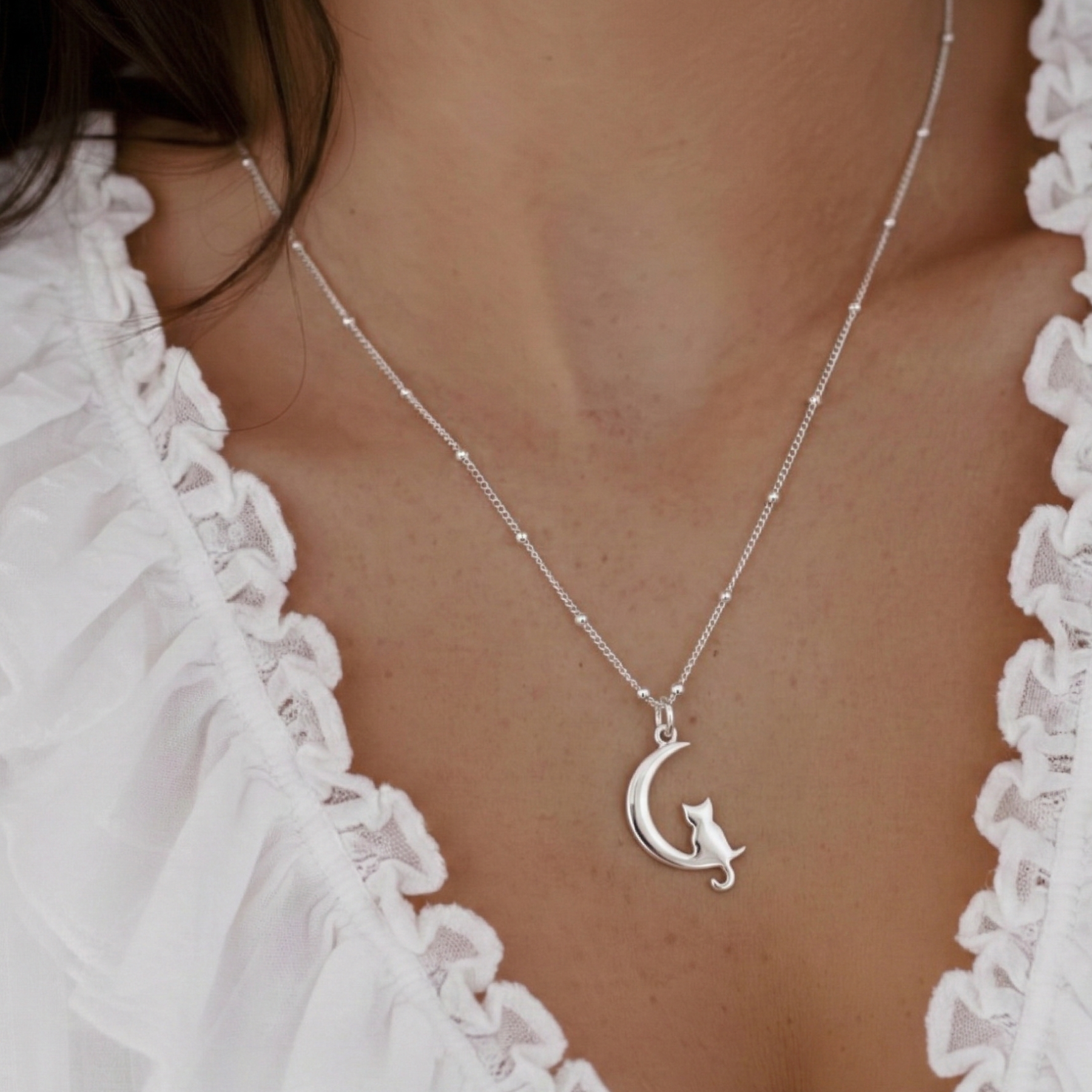 Sterling silver cat necklace worn on chain, animal lover jewellery UK