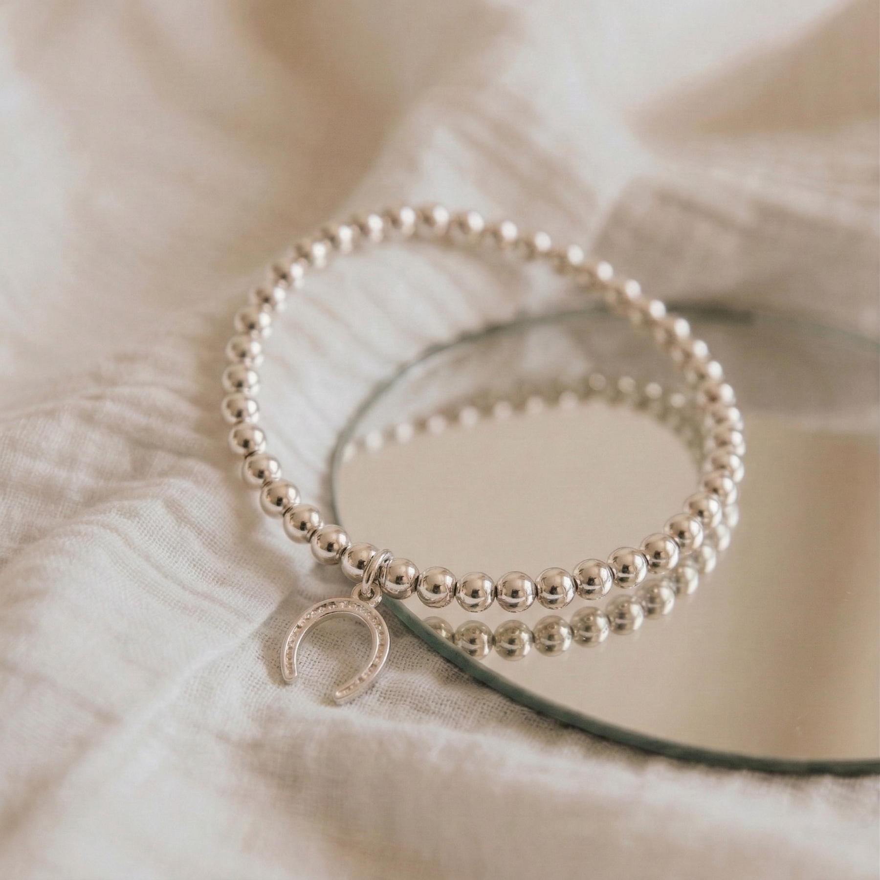Silver horseshoe charm bracelet, stretch bead bracelet for everyday wear UK